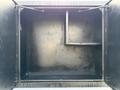 An empty storage compartment of a 2015 Ford F-550 with a shelf and dividers.