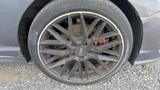 A close-up view of a 2018 Hyundai Sonata wheel featuring a multi-spoke design with visible brake components and accumulated dirt