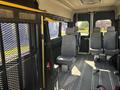 Interior of a 2020 RAM ProMaster 3500 featuring gray seating and a metal mesh partition separating the front from the rear seats