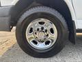 A chrome wheel with a Chevrolet logo and a black tire featuring tread patterns visible on the surface
