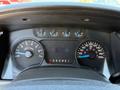 Dashboard of a 2014 Ford F-150 showing gauges for speed, RPM, and fuel level along with a digital display indicating driver information and gear position
