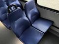 A pair of blue vinyl seats designed for passenger comfort with ergonomic support and a textured surface