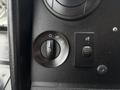 Dashboard controls of a 2018 Ford Econoline featuring a headlight switch and a dial for controlling various interior lights