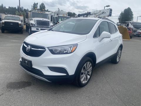 A 2018 Buick Encore in white with a modern design featuring a distinctive grille and alloy wheels parked in an outdoor area