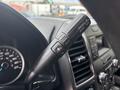 Close-up view of the gear shifter stalk in a 2017 Ford F-150 with buttons for tow/haul mode and sport mode