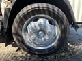 Close-up of a silver wheel on a 2016 Isuzu NPR-HD featuring a six-bolt pattern and black rubber tire with visible tread pattern