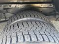 Close-up of a large tire from a 2012 Ford E-450 showcasing its tread pattern and sidewall details
