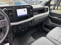 Interior view of a 2023 Ford F-450 Super Duty featuring a digital dashboard display and sleek control panel with various knobs and buttons