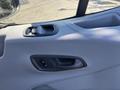 Interior door panel of a 2016 Ford Transit 150 showing the window control and door handle