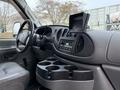 Interior view of a 2007 Ford E-350 showcasing the dashboard and center console with radio controls and a cup holder section