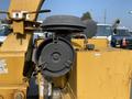 A close-up of the cutting head of a 2010 Vermeer Corporation BC1200XL with a black circular housing and attached clamps