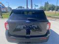Black 2020 Ford Explorer viewed from the rear with a tailgate and rear windshield wiper visible
