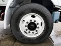Close-up of a tire mounted on a white wheel with multiple lug nuts belonging to a 2020 International MV607 truck