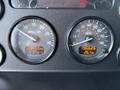 Dashboard of a 2015 Peterbilt 337 showing two gauges for RPM and speed with digital readouts for hours and temperature