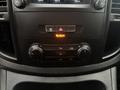 Dashboard controls of a 2021 Mercedes-Benz Metris featuring dials for climate control and a display screen interface