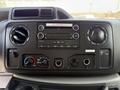 Dashboard control panel of a 2018 Ford E-450 featuring audio system controls knobs and ports for connectivity