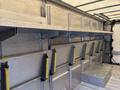 2012 Ford E-450 Super Duty with metal shelving and brackets inside a cargo area designed for storage and transport