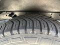 Close-up of a tire from a 2017 Ford Transit-350 showing tread pattern and wear with a focus on the rubber surface