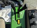 Control panel of a 2021 John Deere 1575 featuring levers and switches for operation and adjustment