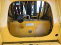 Close-up of the hydraulic pump and control panel of a 2013 JCB 510-56 Loadall with yellow metal casing and visible hoses