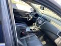 Interior of a 2017 Nissan Murano showing black leather seats a central console and a touchscreen display