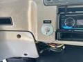 A dashboard of a 2006 Sterling Acterra featuring a toggle switch labeled Beacon and a car stereo visible in the foreground