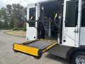 A 2020 Chevrolet Express with a lowered wheelchair lift at the rear entrance ready for access