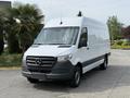 2023 Mercedes-Benz Sprinter van with a white exterior and a black front grille standing in a parking area
