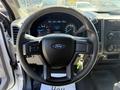 Interior view of a 2017 Ford F-350 SD featuring a steering wheel with the Ford logo and instrument cluster displaying speed and other gauges
