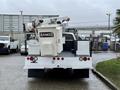 A 2012 Ford F-450 SD with a utility bucket mounted on the back and safety lights mounted on the rear