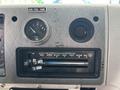 Dashboard controls of a 1994 GMC Vandura 3500 including fuel gauge and air conditioning sliders