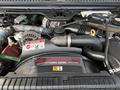An engine of a 2007 Ford F-450 showing a Power Stroke V8 Turbo Diesel label with various engine components and hoses visible