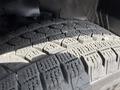 The image shows a close-up of a tire with a textured tread pattern designed for traction and grip