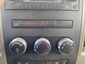 Interior dashboard controls of a 2011 Dodge Ram 5500 featuring climate control knobs and audio system buttons
