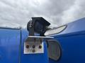 A mounted camera on a bracket attached to a blue vehicle
