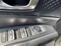 Close-up of the interior controls of a 2022 Kia Sorento including window lift buttons and a circular knob for adjusting seat settings