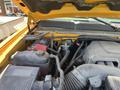 Engine compartment of a 2013 Chevrolet Silverado 1500 showing the battery and various components including hoses and wiring
