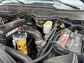 Close-up view of the engine compartment of a 2006 Dodge Ram 2500 showing various components including the battery oil filter and fluid reservoirs