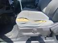 A damaged driver's seat in a 2016 Ford F-350 SD with a torn fabric exposing foam padding