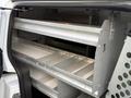 Interior of a 2017 Ford Transit Connect with metal shelving units designed for storage and organization