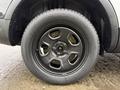 A close-up of a black alloy wheel and tire from a 2019 Ford Explorer showing five spokes and a smooth tire tread