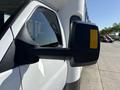 Close-up of the side mirror of a 2017 Chevrolet Express van showcasing the reflective surface and angular design
