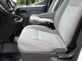 Interior view of a 2017 Ford Transit showcasing two gray front seats with a simple design and fabric upholstery