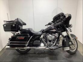 2012 Harley-Davidson FLHTC touring motorcycle in black with chrome accents and a large windshield