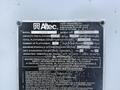 A metal identification plate from an Altec Industries lift featuring model and serial numbers along with operation and safety instructions