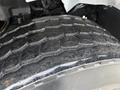 Close-up of a worn tire from a 2016 International 7400 showing deep treads and visible dirt and wear on the rubber surface