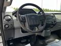 Interior view of a 2016 Ford F-550 featuring the steering wheel dashboard controls and audio system