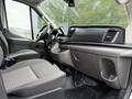 Interior of a 2022 Ford Transit showing the driver's seat passenger seat dashboard and central console with a display screen