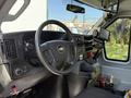 Interior view of a 2020 Chevrolet Express featuring a steering wheel dashboard controls and a mounted display screen