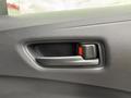 A door handle of a 2025 Toyota Corolla featuring a sleek design with a red release button